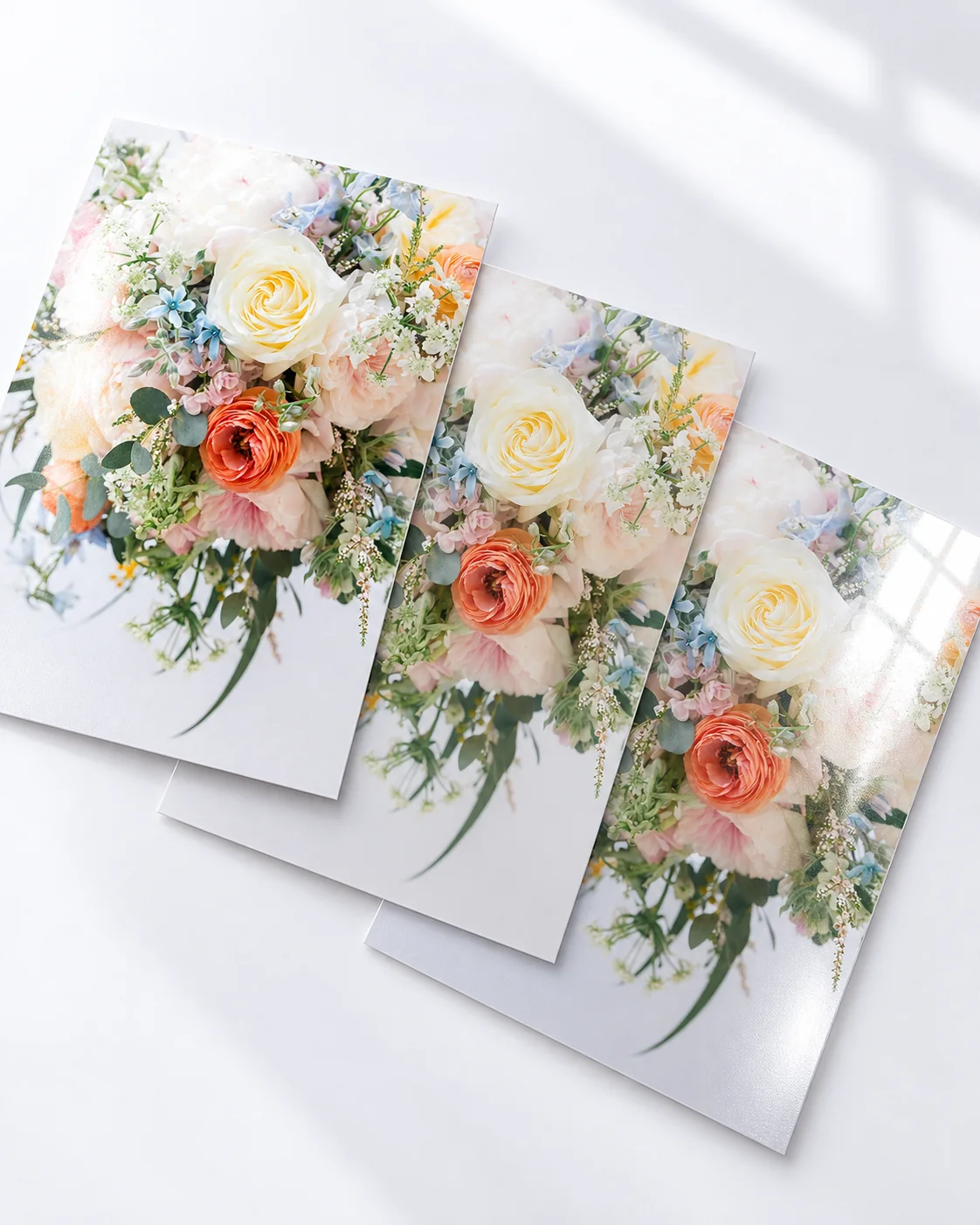 Three prints of a bouquet on different paper finishes